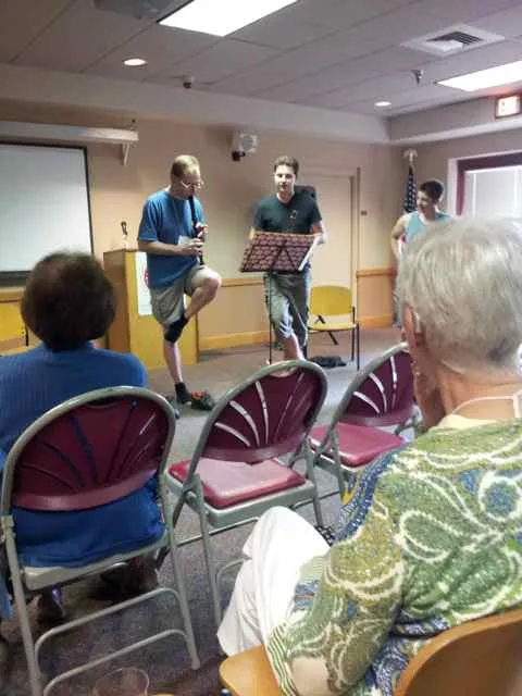 Mike raising leg, with James and Emily